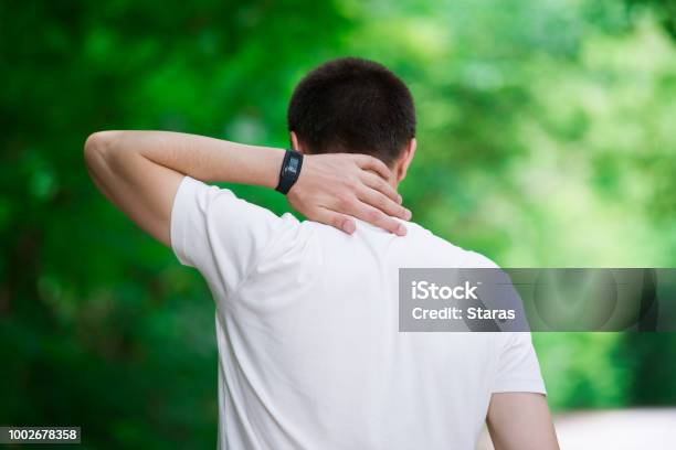 Man With Back Pain Neck Injury Trauma During Workout Stock Photo - Download Image Now