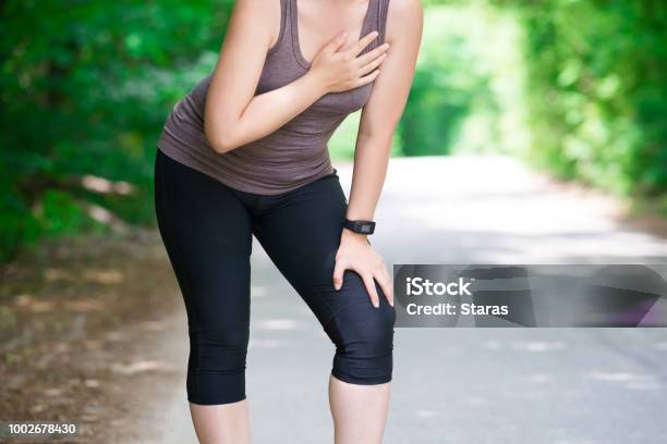 Woman With Heart Attack Injury While Running Trauma During Workout Stock Photo - Download Image Now