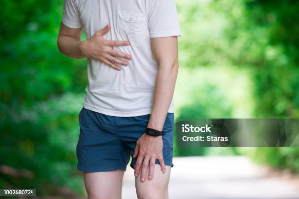 Man With Heart Attack Injury While Running Trauma During Workout Stock Photo - Download Image Now