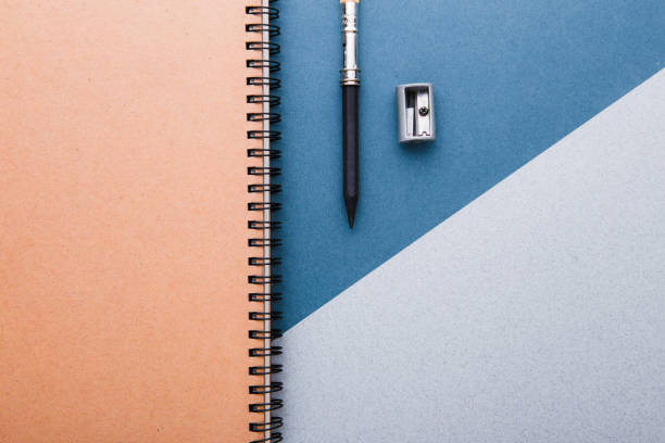 istock A pencil, a pencil sharpener and crafting notebooks on a green-gray background. 1002681448