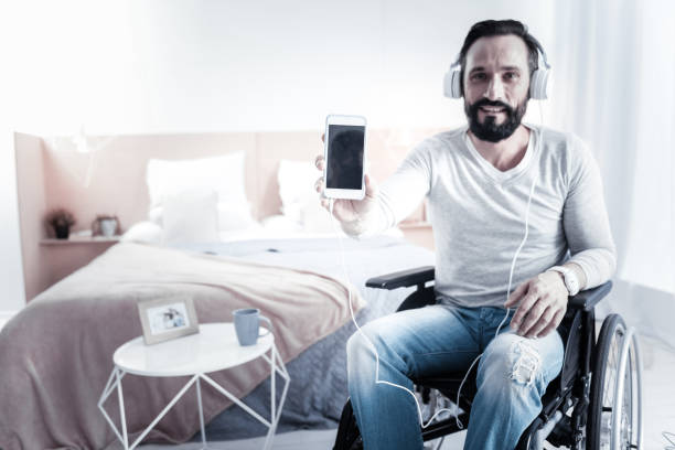 istock Attractive differently abled man demonstrating his smartphone 1002684252
