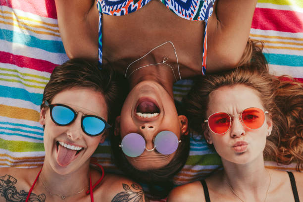 istock Close up of women enjoying on beach 1002687734