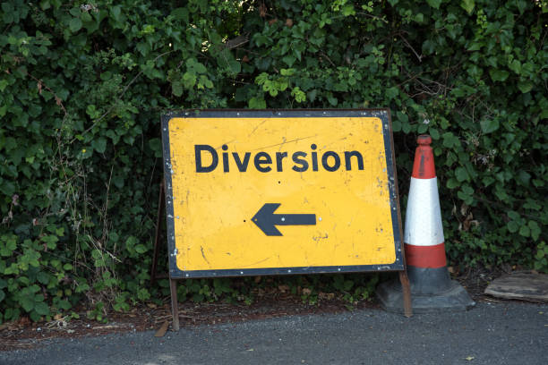 istock Road diversion sign and cone 1002689494