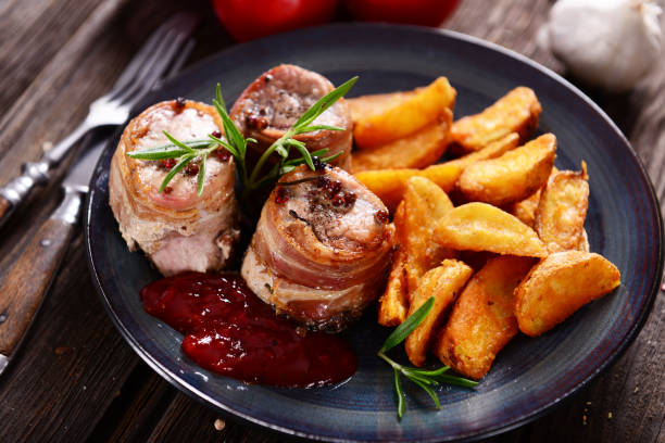 Meat rolls Meat chunks wrapped with bacon served with potato wedges bacon wrapped stock pictures, royalty-free photos & images