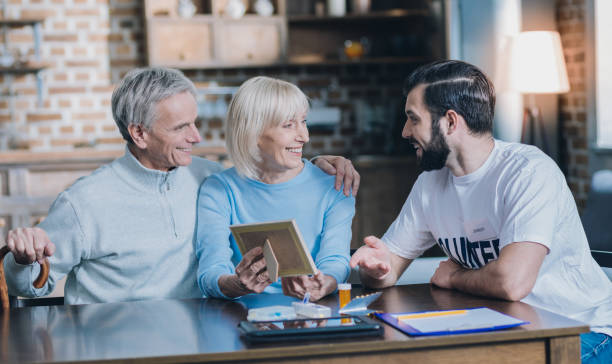 istock Content spouses showing photos to a young man 1002695588