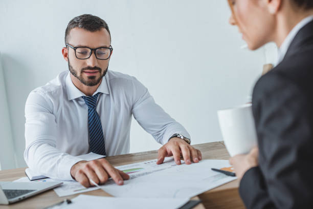 istock male and female financiers working with documents in office 1002705140