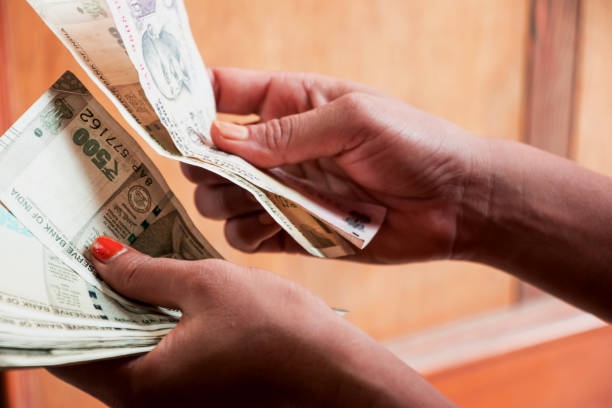istock Image of hand counting Indian currency 1002706108