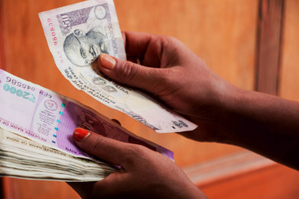 istock Image of hand counting Indian currency 1002706210