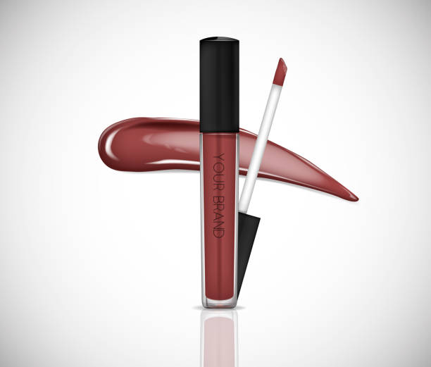 istock Brown Liquid lipstick, Lip gloss in elegant glass bottle with black lid, closed and open container with brush, isolated . Make up smear. 1002709994