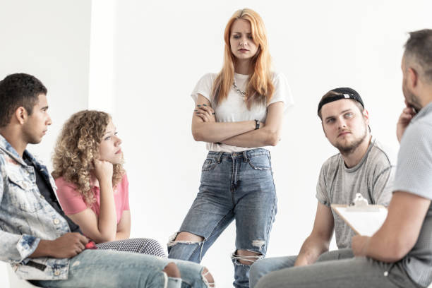 istock Difficult teenagers talking with psychologist during session in the office 1002710482