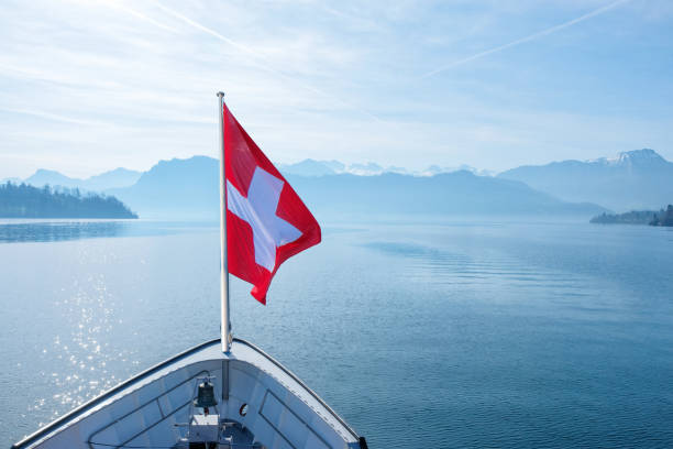 istock Swiss flag flying on boat and Rigi mountain view background 1002713282