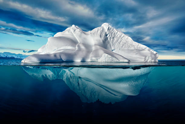 iceberg with above and underwater view taken in greenland. - cold frozen sea landscape imagens e fotografias de stock