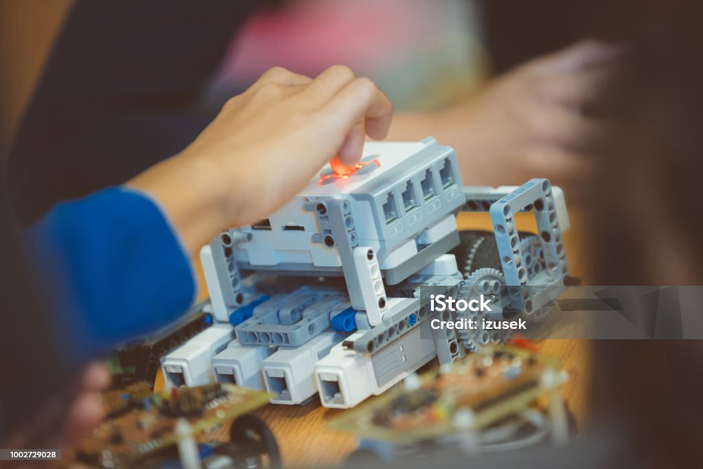 School students learning robotics School children learning robotics during engineering science project. Close up of robot. Unrecognizable people. Child Stock Photo