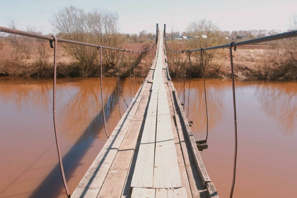 Suspended wooden bridge over the river outdoor