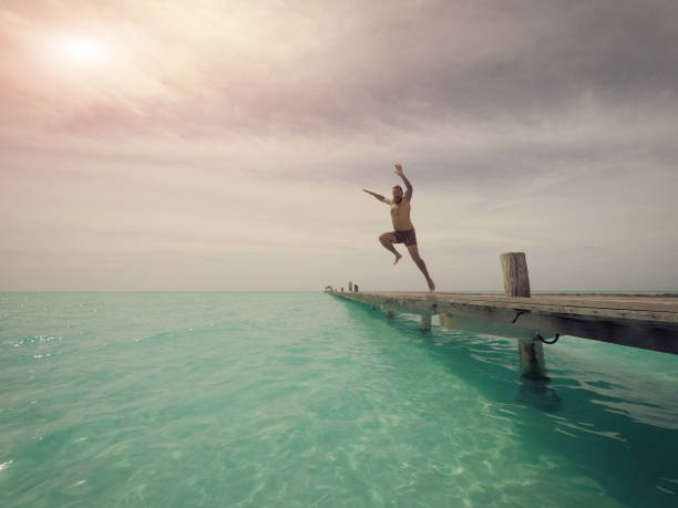 istock Man jumping into the sea 1002732402