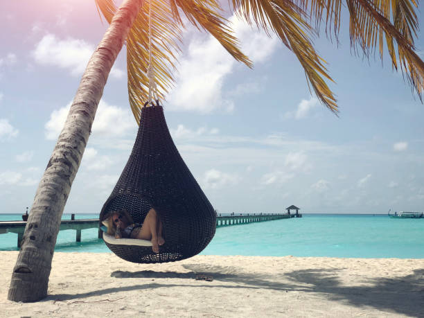 istock Tattooed woman on the beach 1002733372