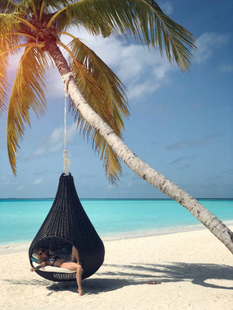 istock Tattooed woman on the beach 1002733398