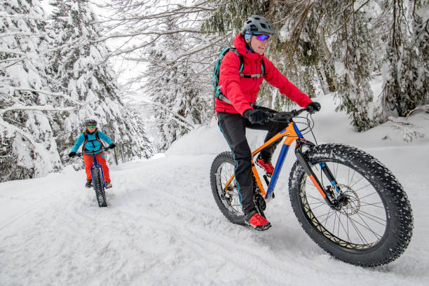 istock Couple riding their fat bikes on snowy forest trail 1002736074