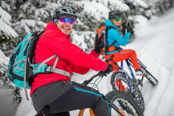 istock Couple riding their fat bikes on snowy forest trail 1002736088