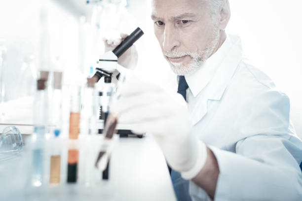 istock Smart handsome biologist taking a test tube 1002736604