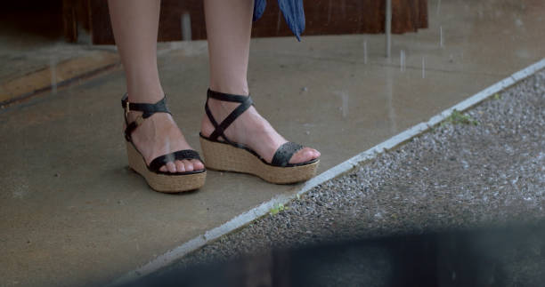 istock woman watching rain at cafe. 1002737780