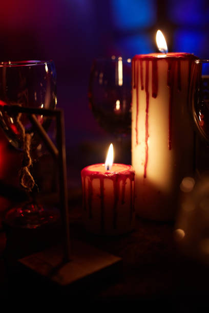 istock The burning candles and empty glasses on a table. 1002737924
