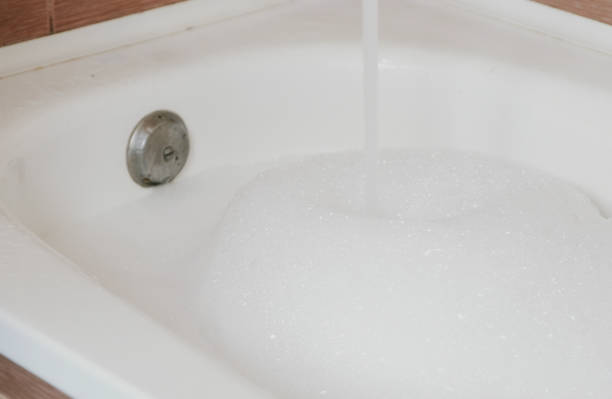 istock Stream of water pouring into the bath with foam. 1002738198