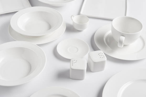 istock close up view of different plates, cup, bowl, saltcellar and pepper caster on white table 1002740652