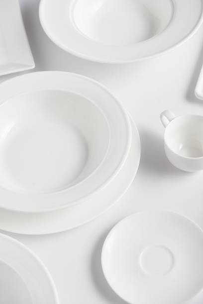 istock high angle view of various plates and cup on white table 1002740684