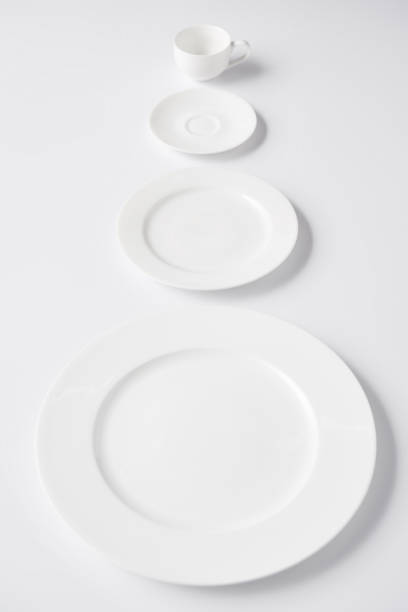 istock selective focus of arranged various plates and cup on white table 1002740752