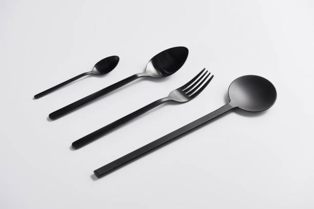 istock close up image of arranged salad spoon, fork and spoons on white table 1002740780