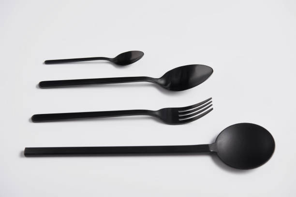istock close up view of arranged salad spoon, fork and spoons on white table, minimalistic concept 1002740790