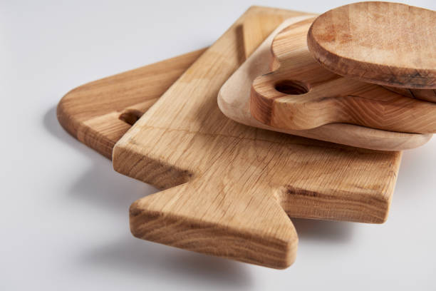 istock close up view of stack of different wooden cutting boards on white table 1002740796