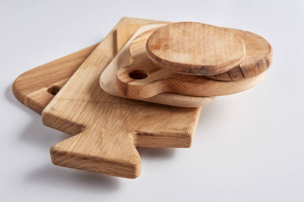 istock selective focus of stack of different wooden cutting boards on white table 1002740808