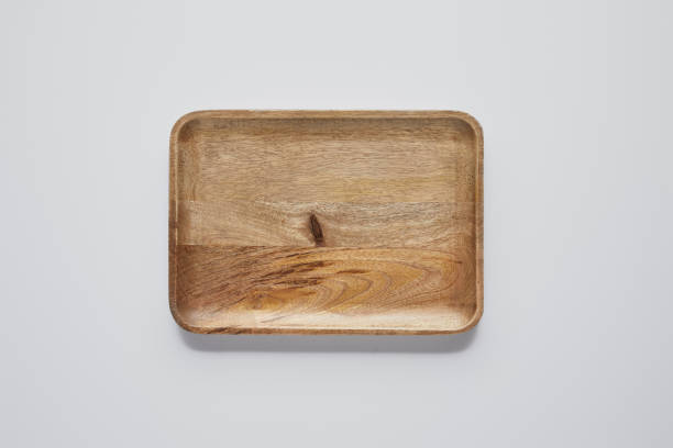 istock top view of wooden tray on white table, minimalistic concept 1002740954