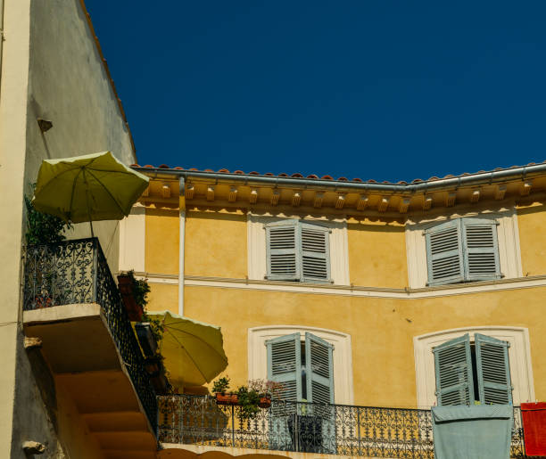 istock Traditional Provencal yellow facade with blue shutters 1002741890