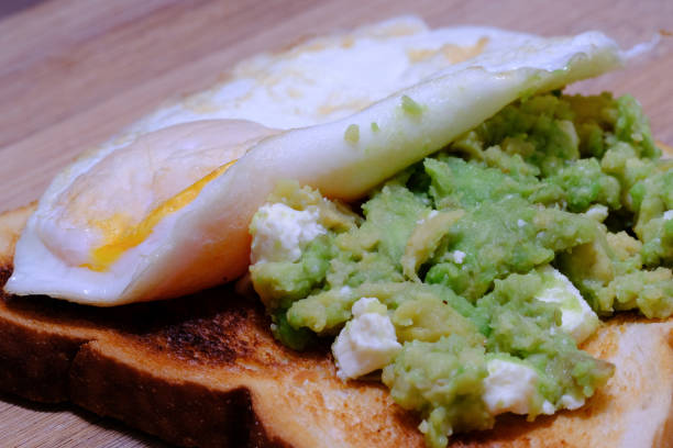 istock Smashed avocado and feta with a fried egg on toast 1002742108