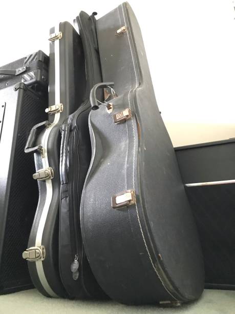 istock Guitars in cases and amplifiers for music hobby 1002745002