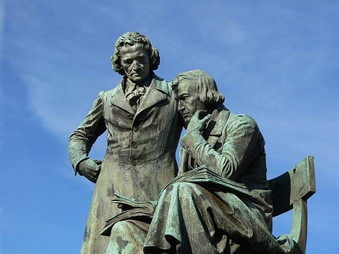 Grimm Brothers - Jacob and Wilhelm Grimm - famous literary national monument in Germany, designed and built by the sculptor Syrius Eberle. The bronze statue was erected 1896 and is situated on the marketplace in front of the town hall in Hanau city. The Grimm Brothers were among the first and best-known collectors of folk tales.