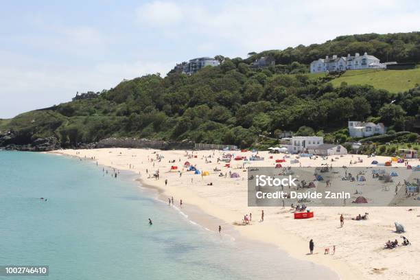 Holidaymakers And Sunbathers On Newquay Beach With Azure Seas Newquay Cornwall Uk Stock Photo - Download Image Now