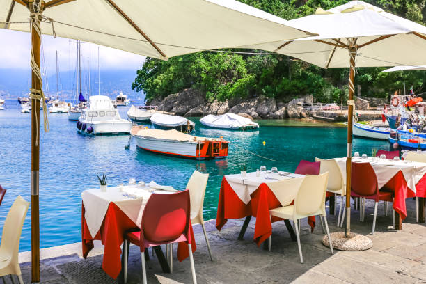 Restaurant in Portofino Harbor, Liguria, Italy Table in Portofino Harbor, Liguria, Italy portofino stock pictures, royalty-free photos & images