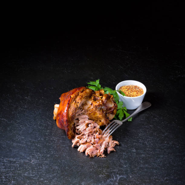 istock fresh roasted knuckle of pork with mustard 1002749710