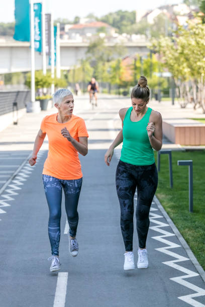 istock Young and senior sportswoman running 1002750054