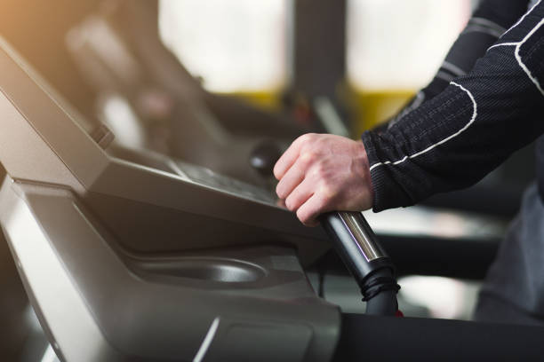 istock Unrecognizable man in gym running on treadmill 1002752530