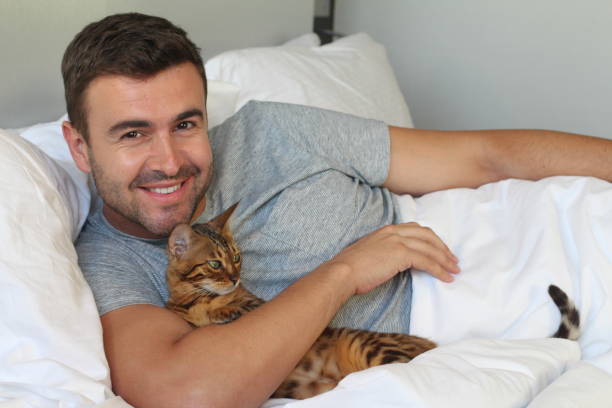 istock Cozy man in bed with his pet 1002753248