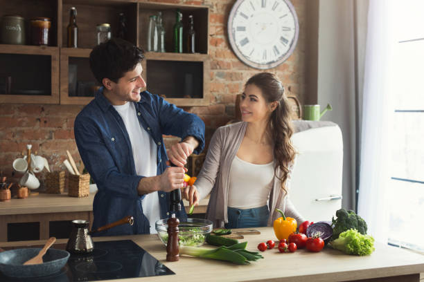 istock Happy couple cooking dinner together 1002753666