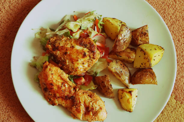 istock A natural chicken steak with potatoes on ceramic plate 1002756282