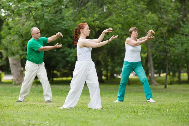 Photo of group of people practice Tai Chi Chuan in a park.  Chinese management skill Qi's energy.