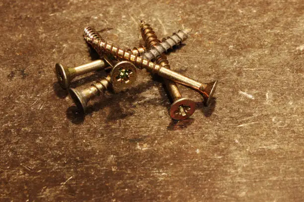 A gold metal screws for attaching something in your home