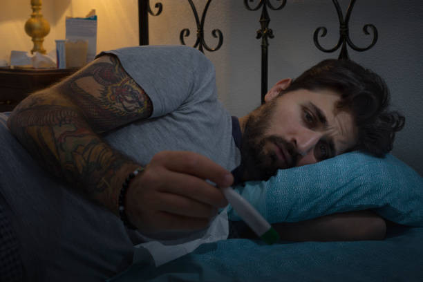 istock Young affected Man in His Bad Looks the thermometer 1002757248